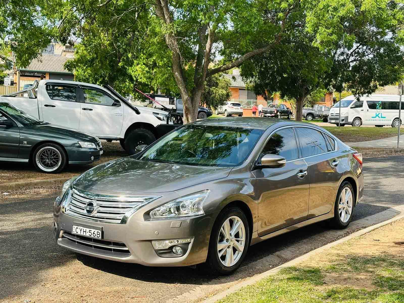A Silver Car Is Parked On The Side Of The Road — Brody’s Car Detailing In Oxley Vale, NSW