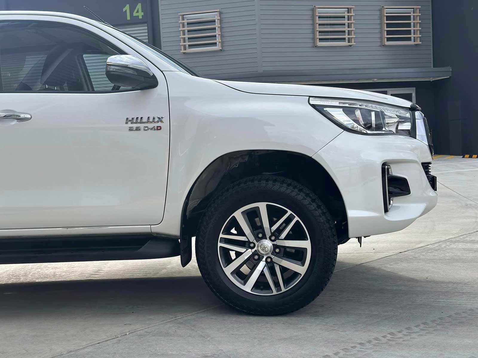 A White Toyota Hilux Truck Is Parked In Front Of A Building — Brody’s Car Detailing In Oxley Vale, NSW