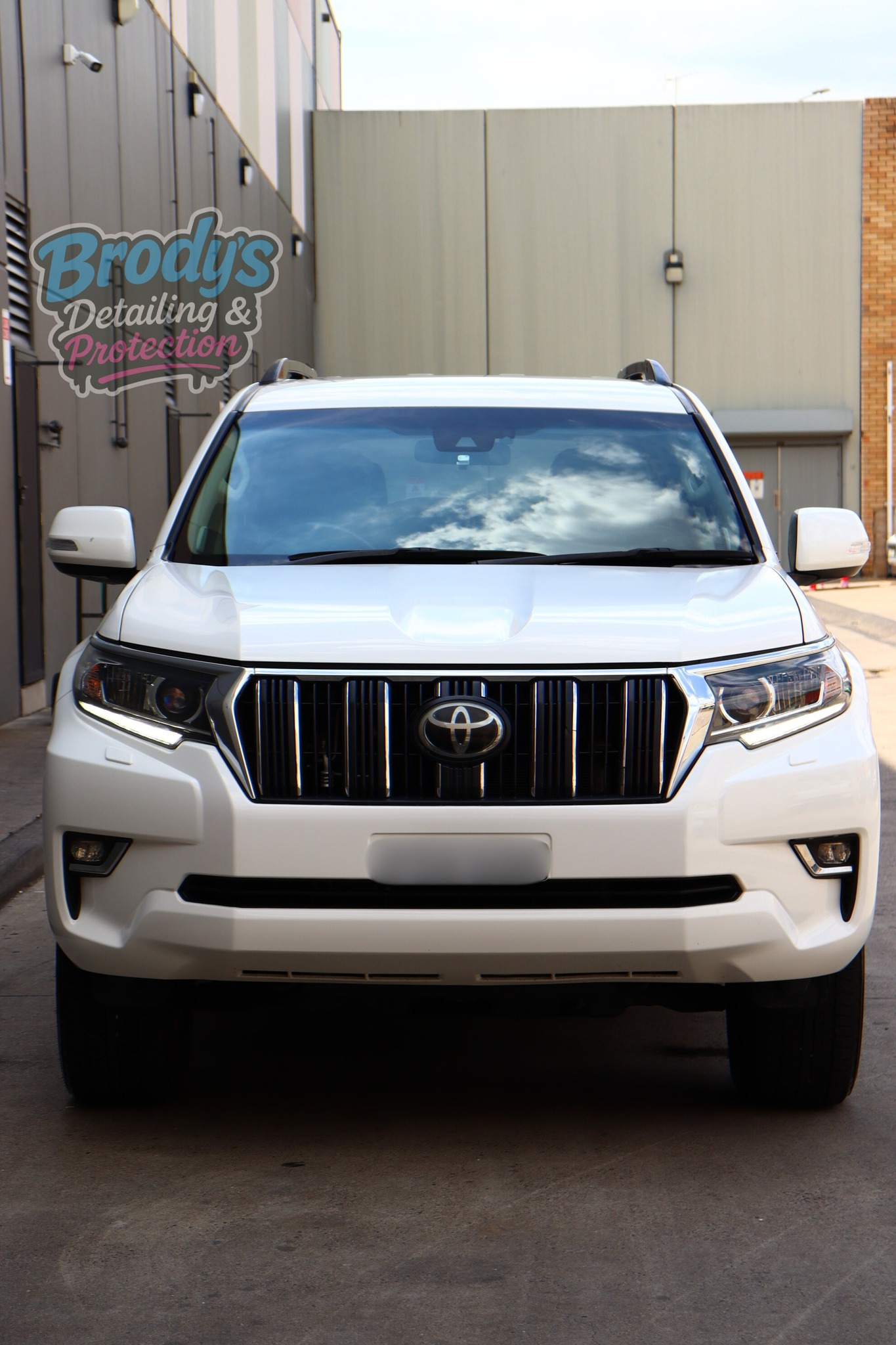 White Toyota Prado SUV Parked in Front of a Building — Brody’s Car Detailing In Tamworth, NSW