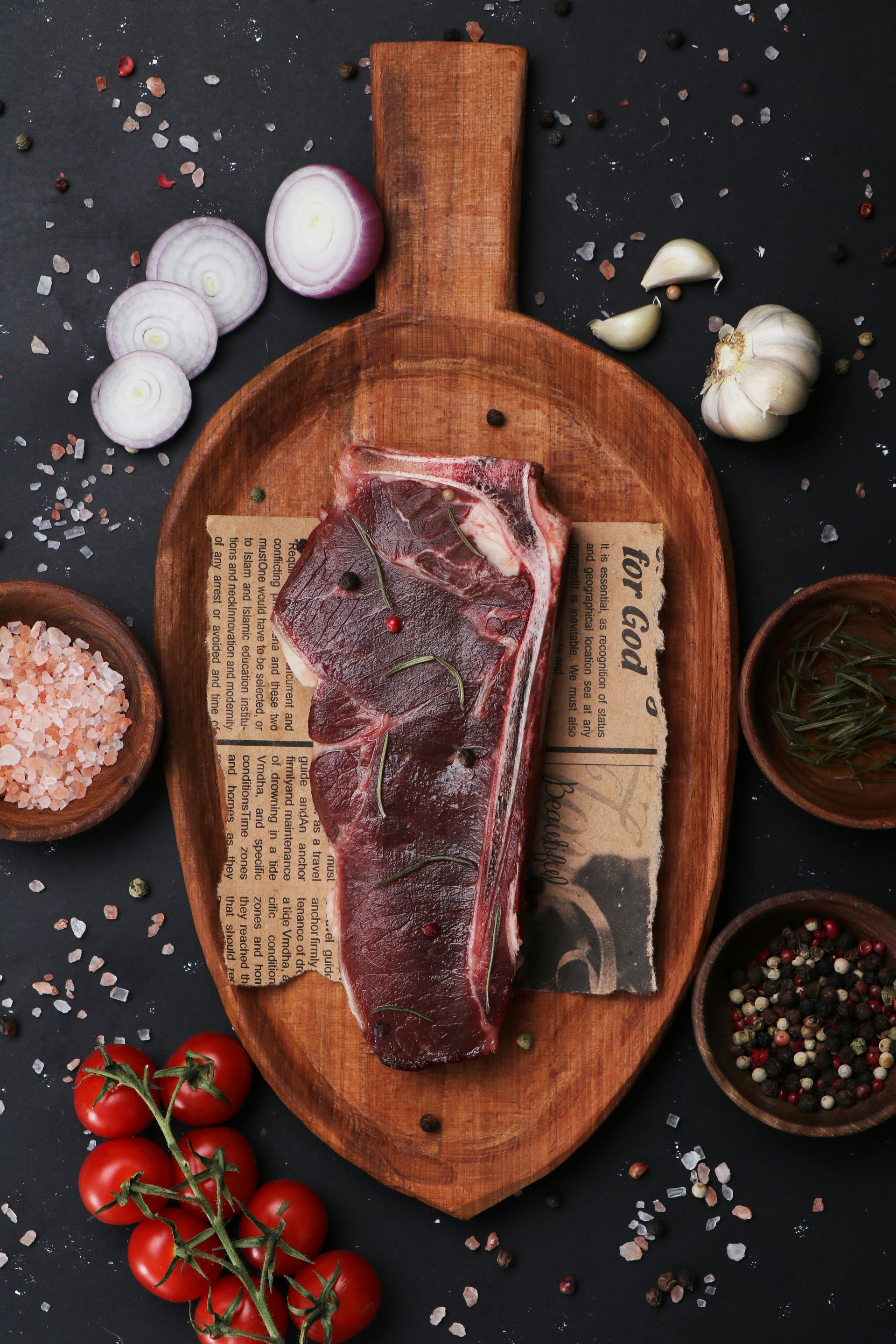 A man and a boy are cutting meat at a market.