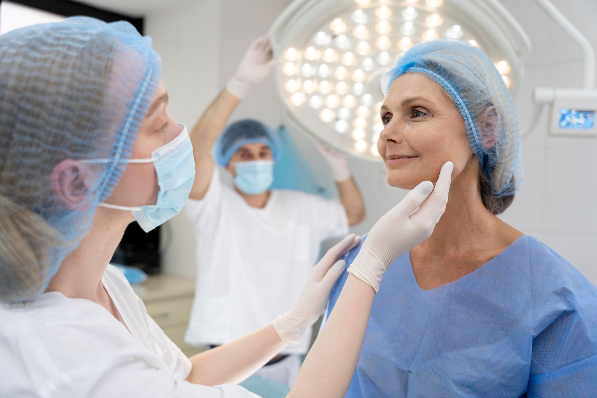 A woman is being examined by a surgeon in an operating room.