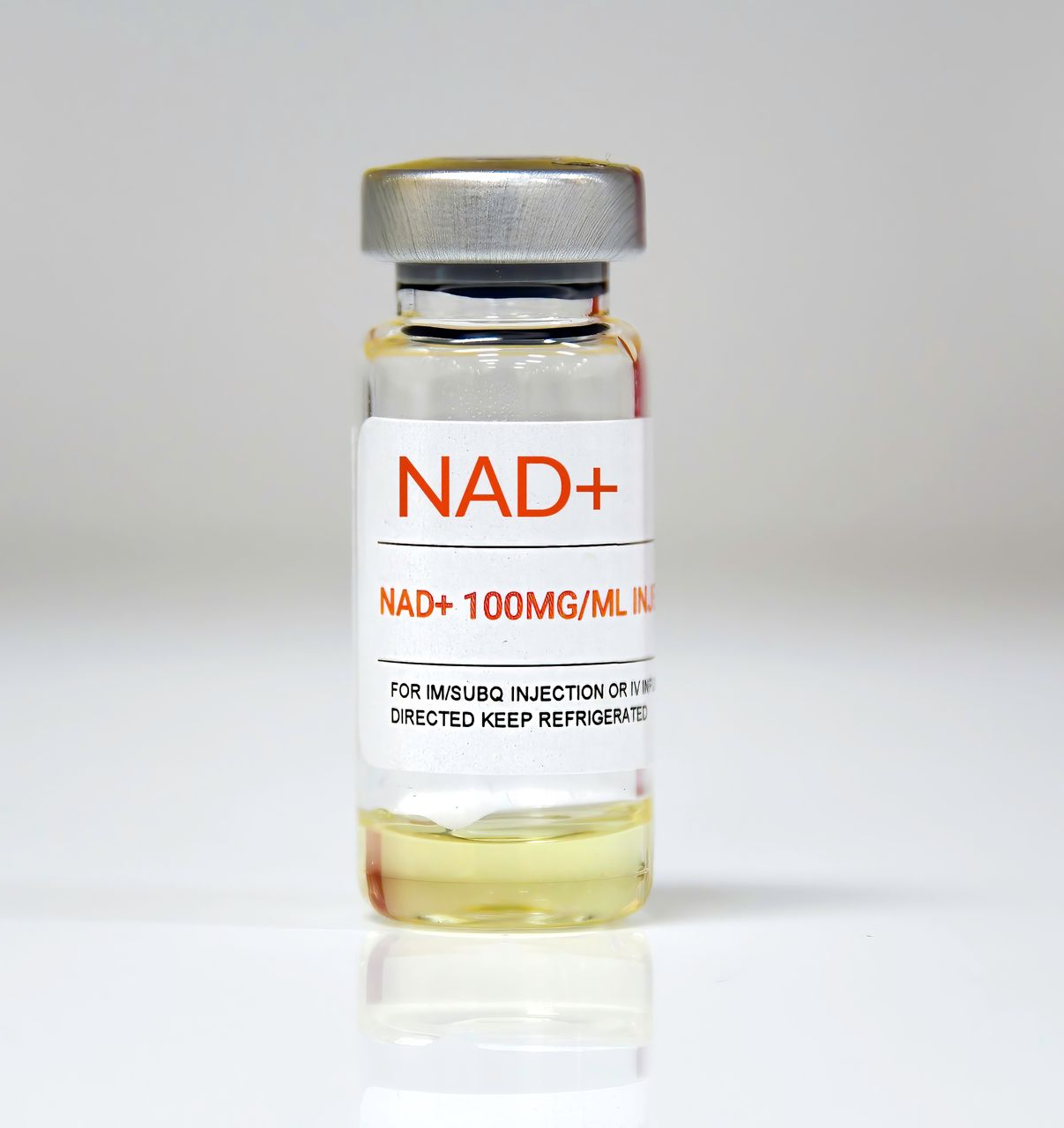 Vial of NAD+ 100mg/mL liquid medication with orange label and silver cap, against a white background.