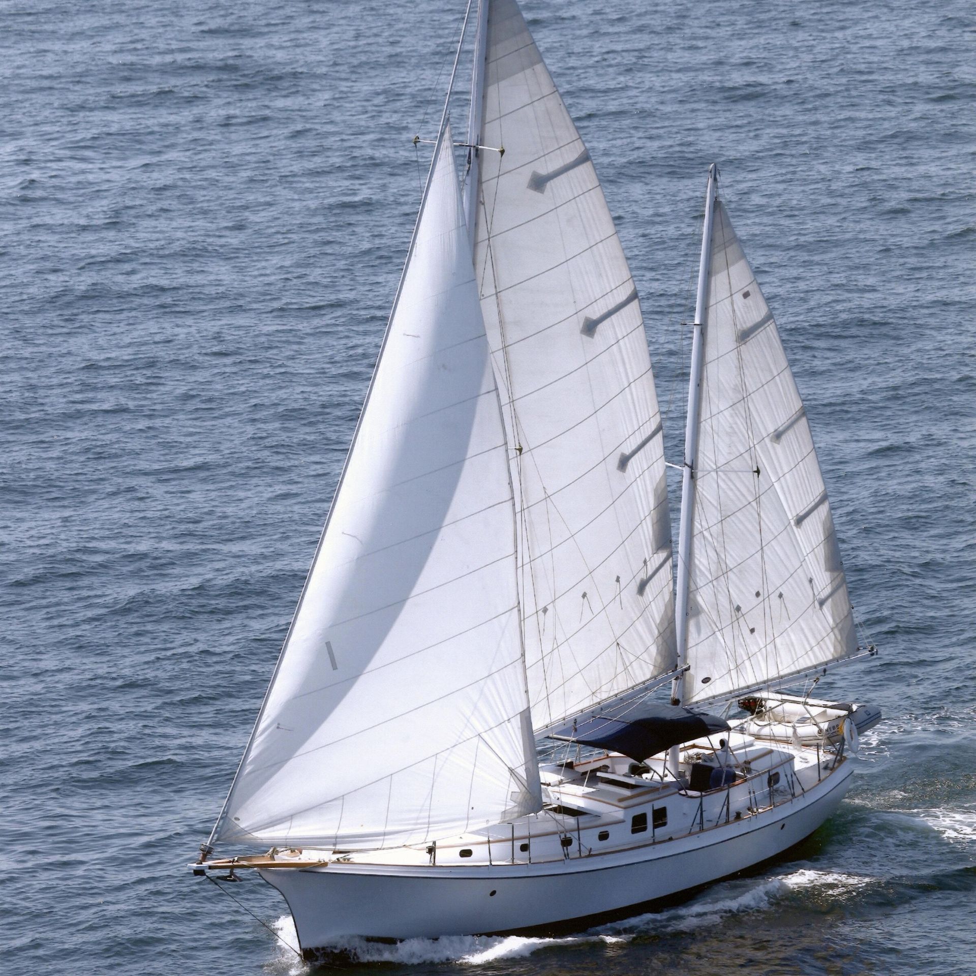 A sailboat is floating on top of a body of water