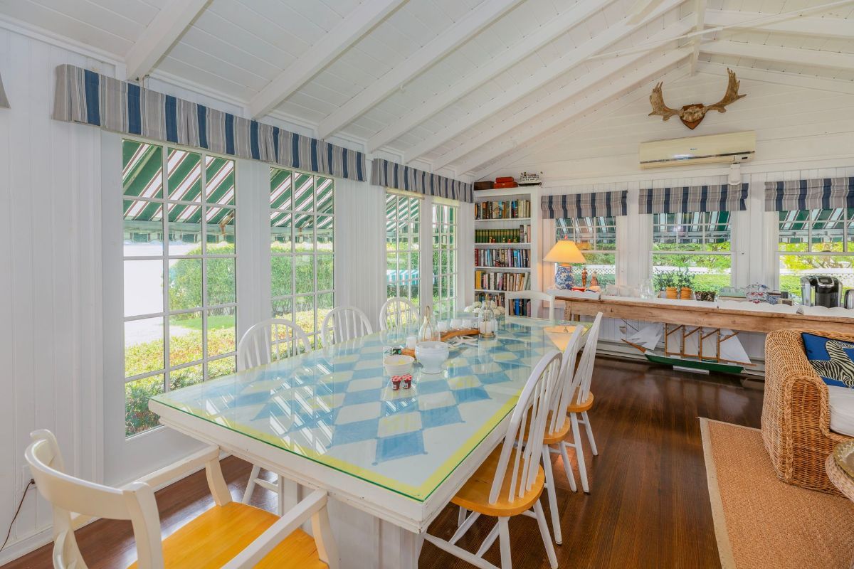 A dining room with a checkered table and chairs