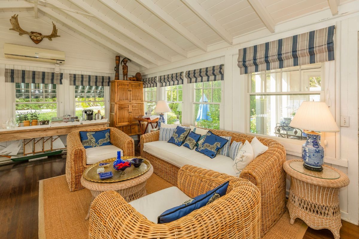 A living room with wicker furniture and a couch.