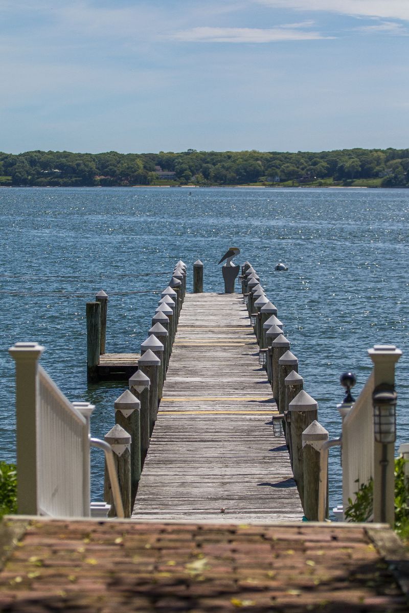 A wooden dock leading into a large body of water.