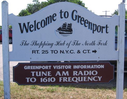 A sign that says welcome to greenport on it
