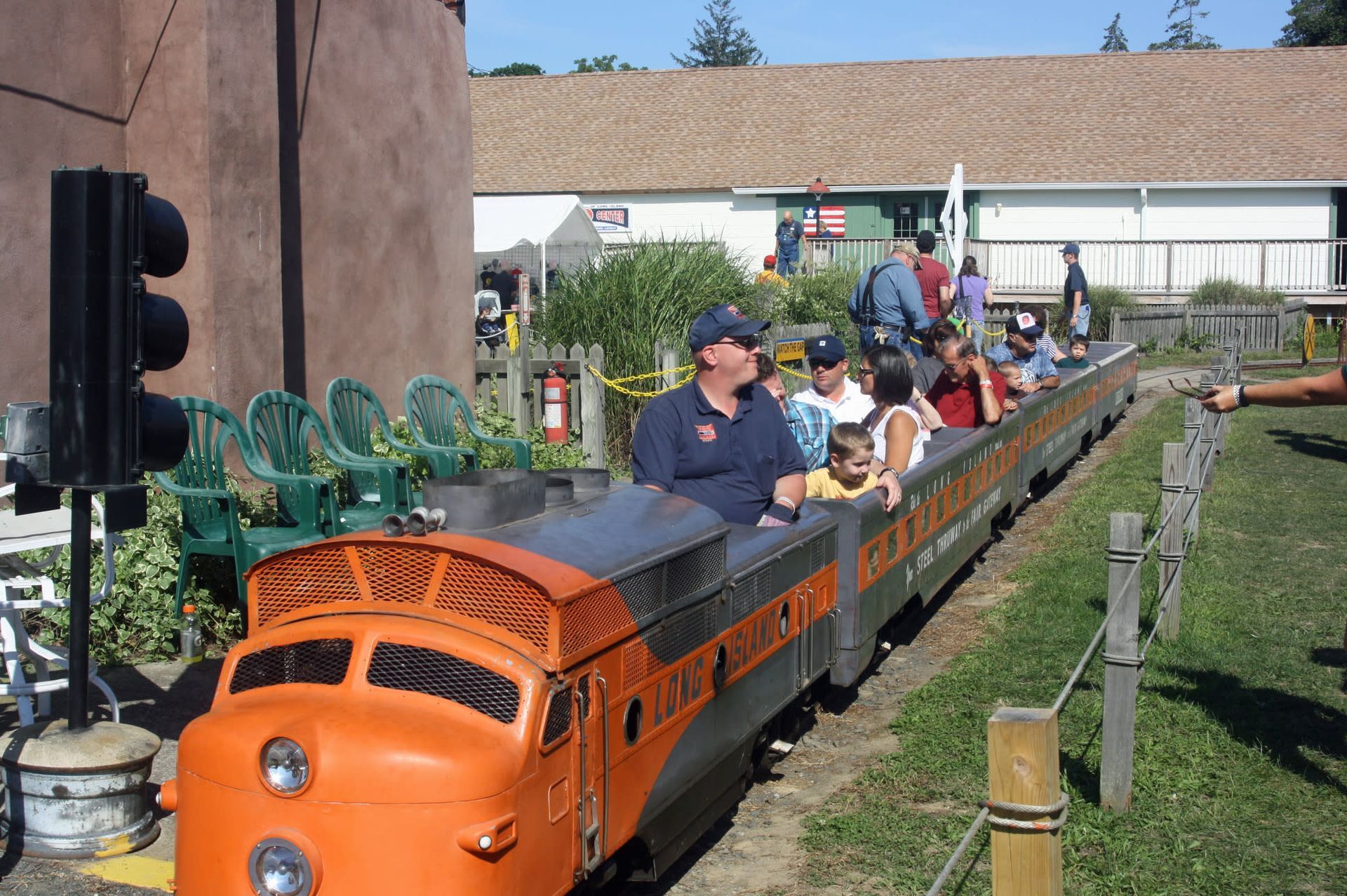 A group of people are riding on a small train