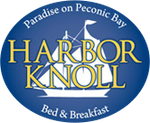 Logo for Harbor Knoll Bed & Breakfast. Blue oval with sailboat design and gold text on a blue background.