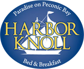 The logo for harbor knoll bed and breakfast has a boat on it.
