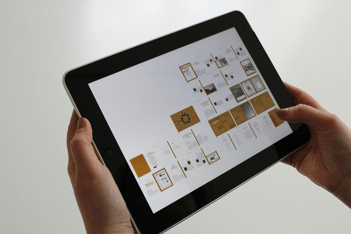 A person is holding a tablet in their hands