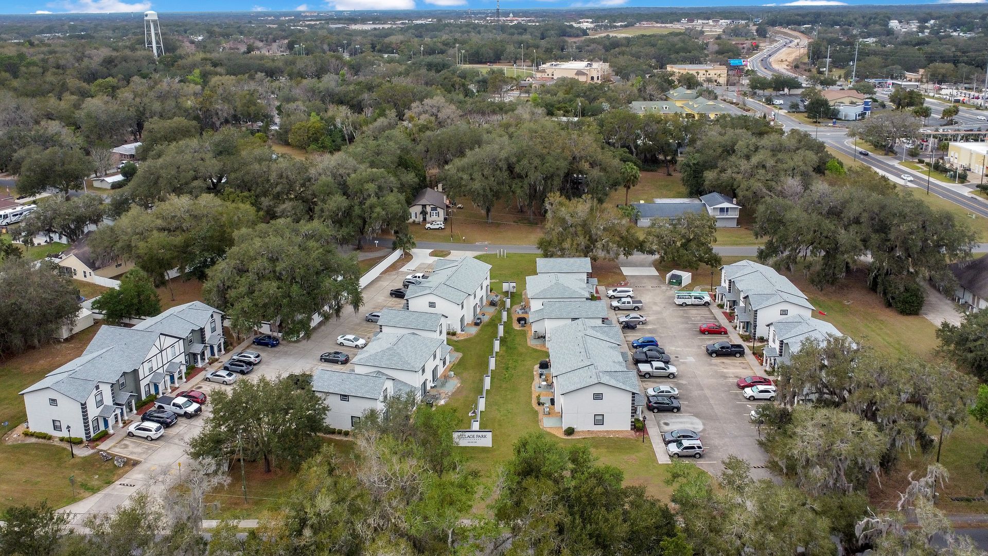 An aerial view of a residential area with lots of trees and apartment buildings.