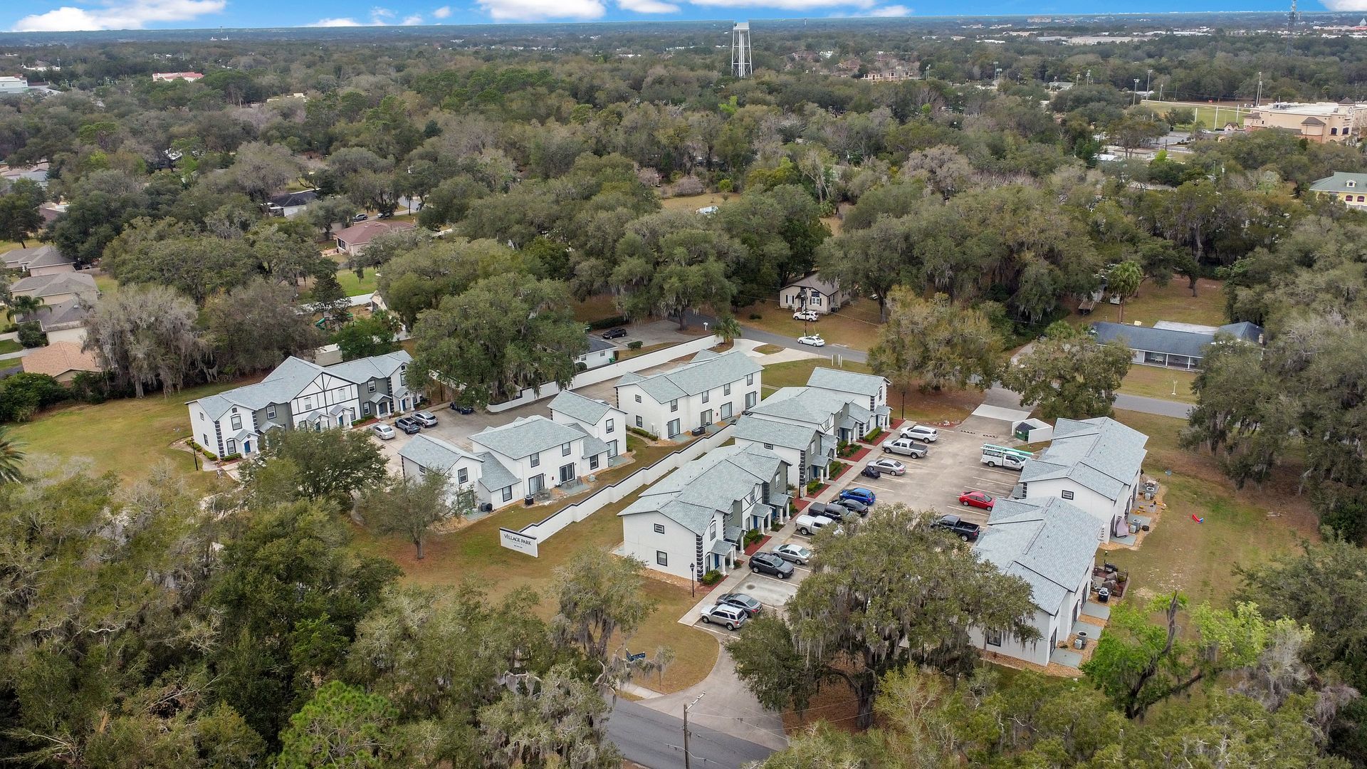 An aerial view of a residential area with lots of trees and apartment buildings.