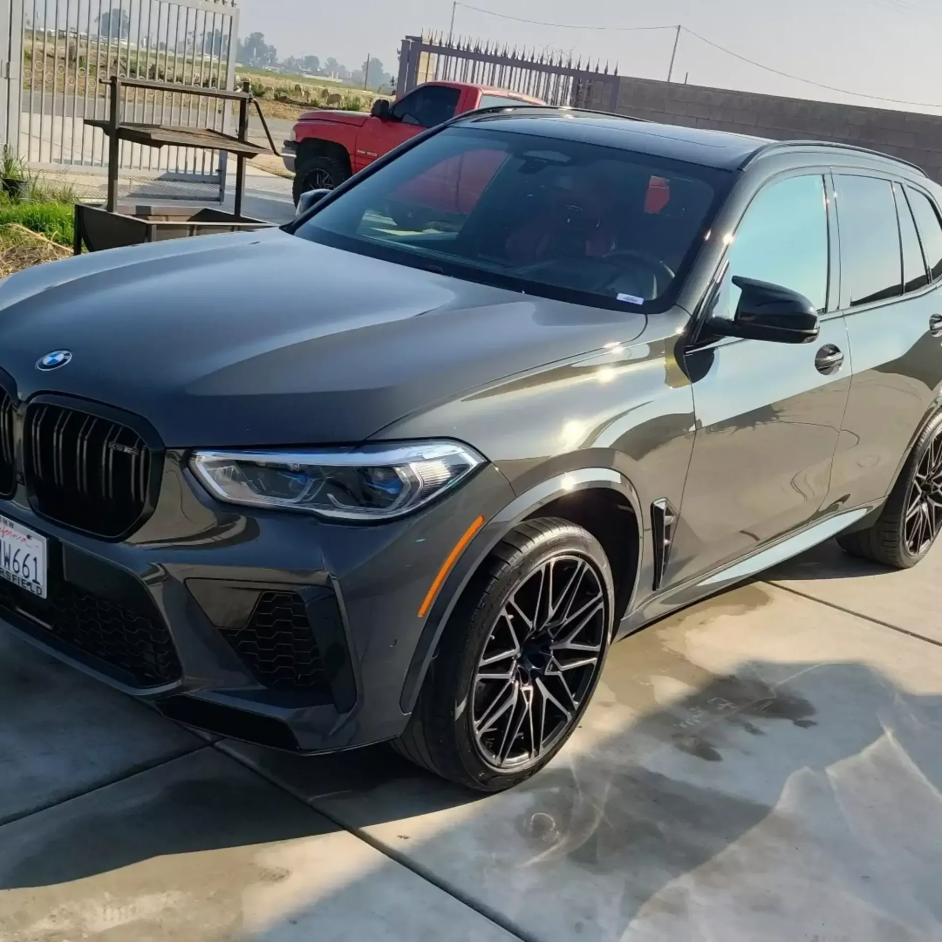 A bmw x5 is parked on the side of the road
