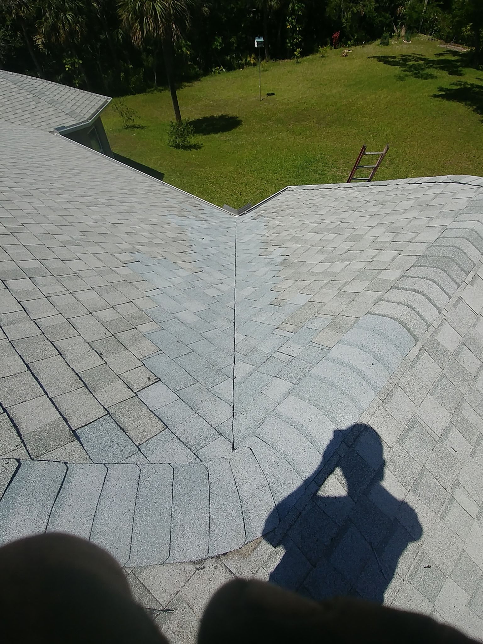 A skilled worker repairs a roof using tools and materials, ensuring its durability and structural integrity.