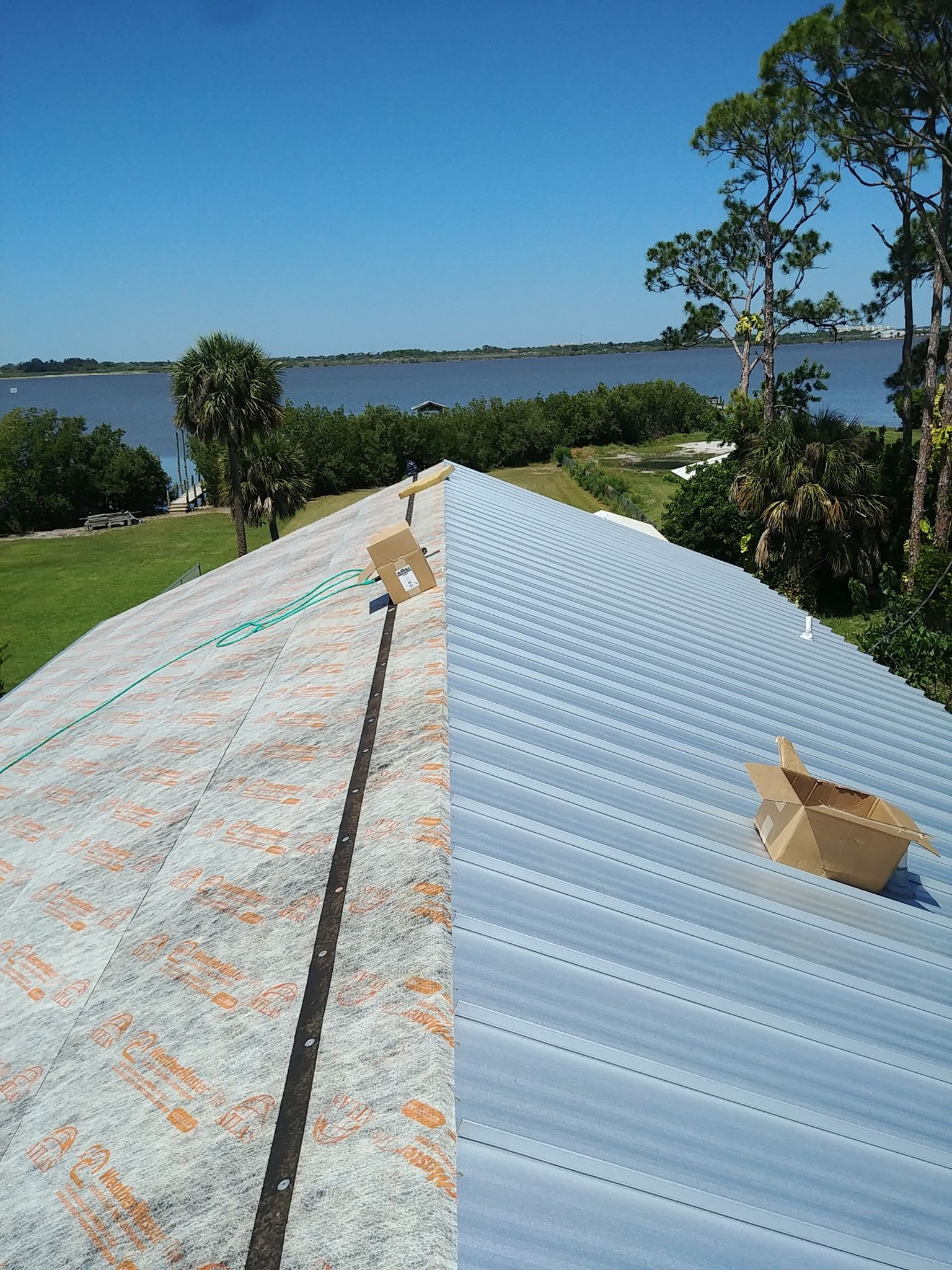 a man wearing a hard hat is working on a roof