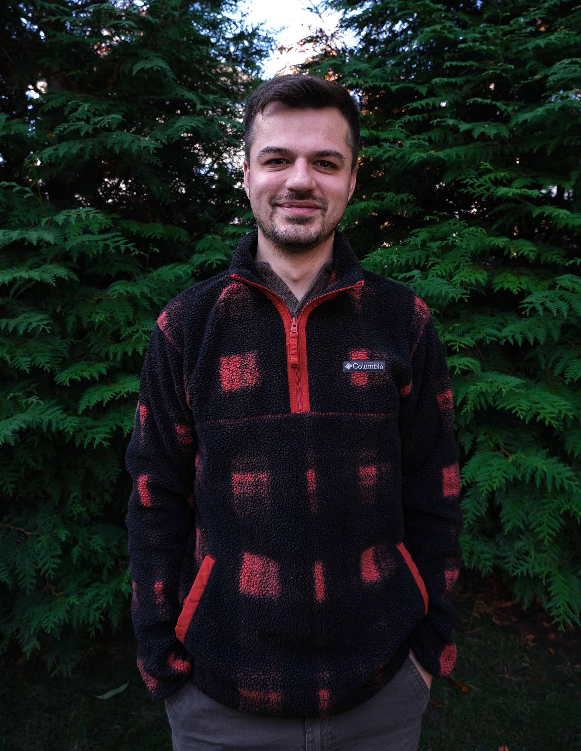 A kitchen counter with a tray of wine glasses and a vase of flowers.