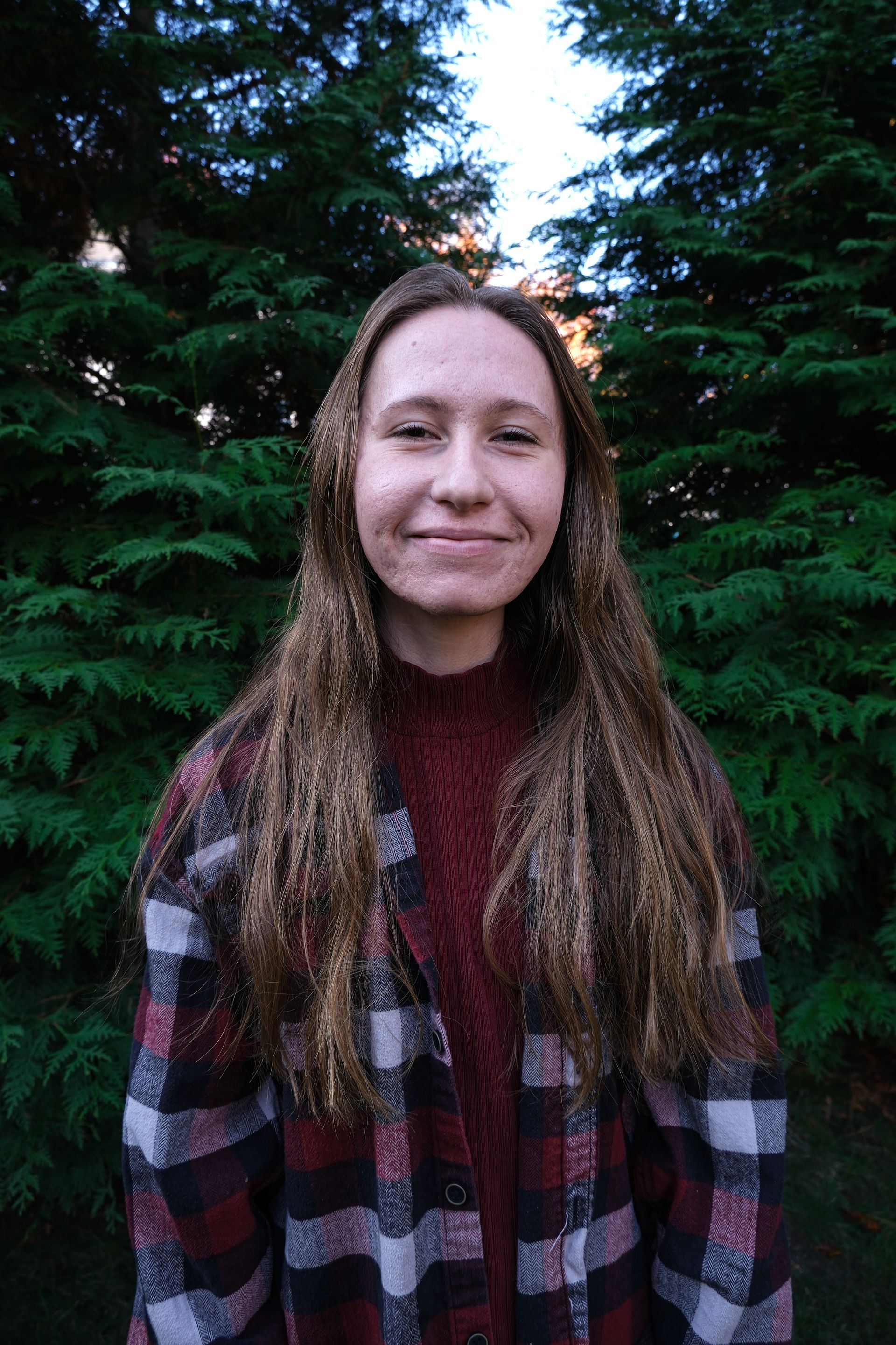 A kitchen counter with a tray of wine glasses and a vase of flowers.
