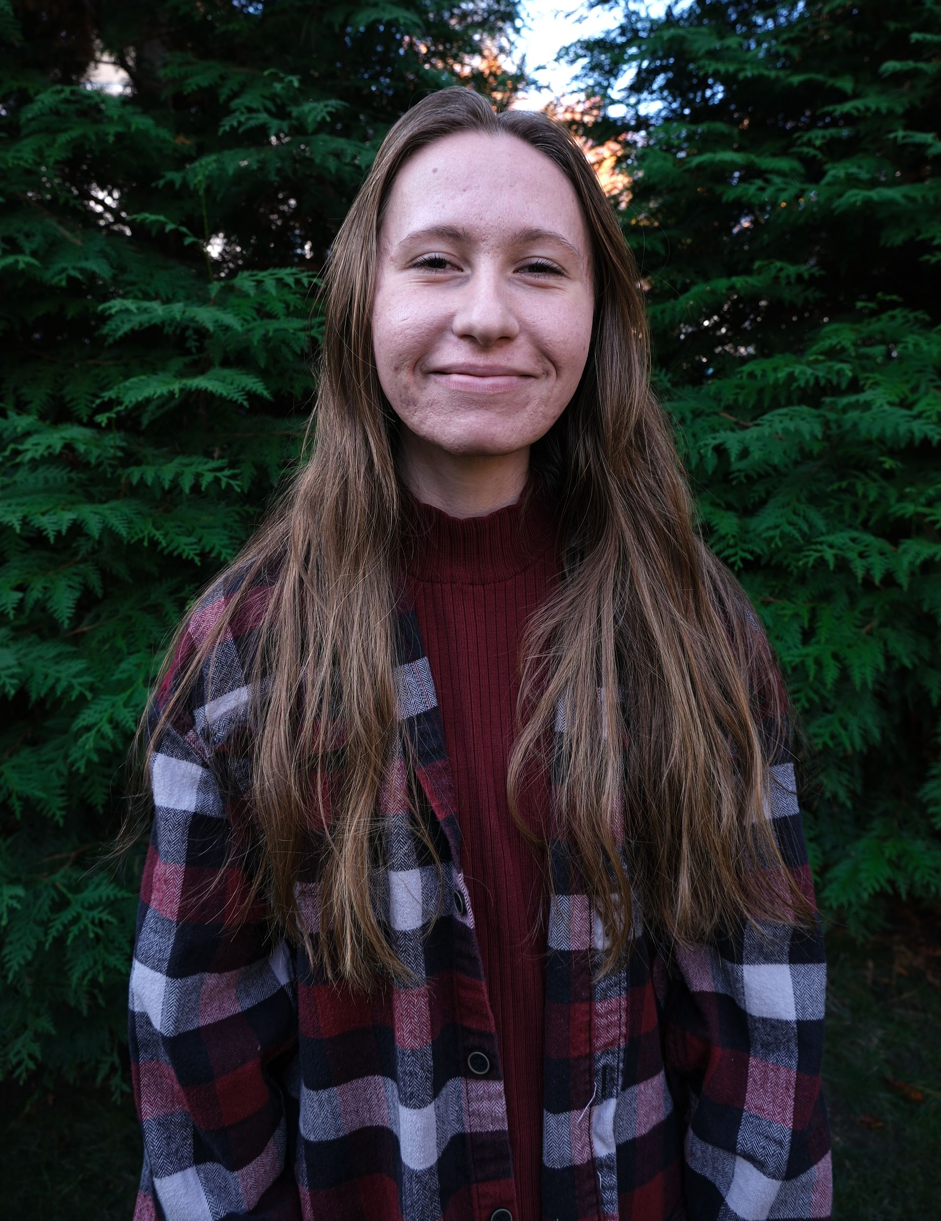 A kitchen counter with a tray of wine glasses and a vase of flowers.
