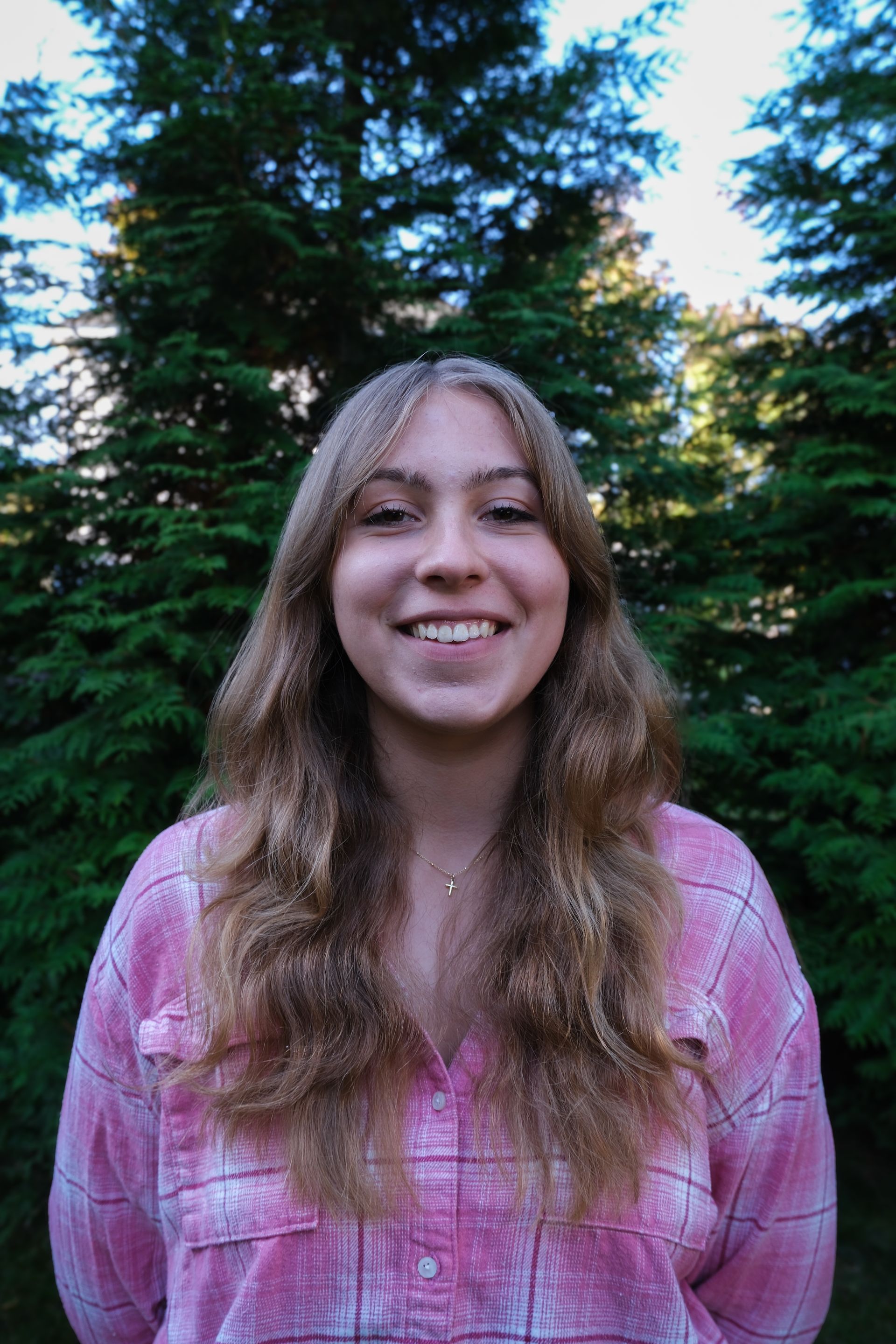 A kitchen counter with a tray of wine glasses and a vase of flowers.