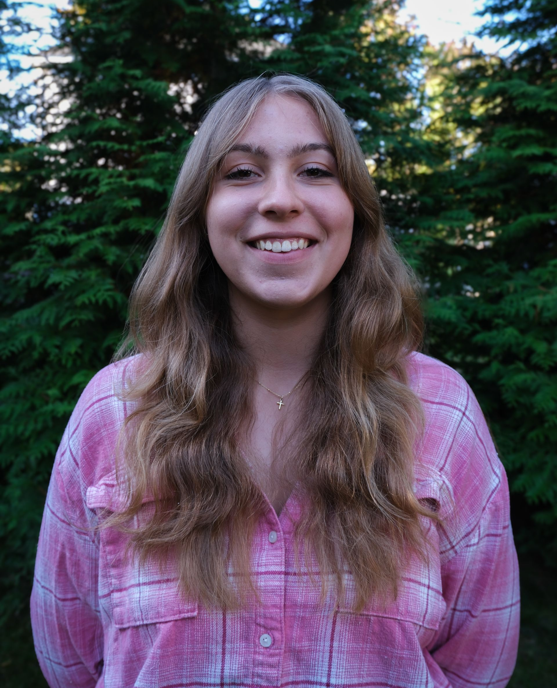 A kitchen counter with a tray of wine glasses and a vase of flowers.