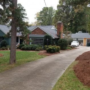 House with a brick chimney and a long driveway