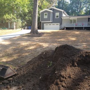 Pile of dirt in front of a house being renovated