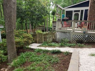 A wooden deck and pathway lead to a house