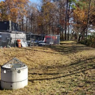 Concrete structure in a grassy field