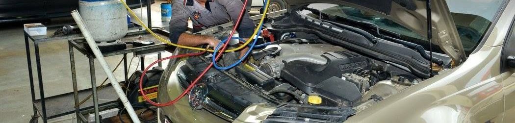 Man Repairing Air Conditioning — Townsville, QLD — Leslie's Auto Electrical & Air-Conditioning