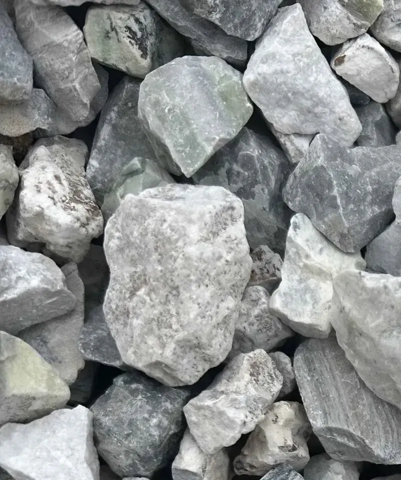 Pile of gray and green gravel rocks.