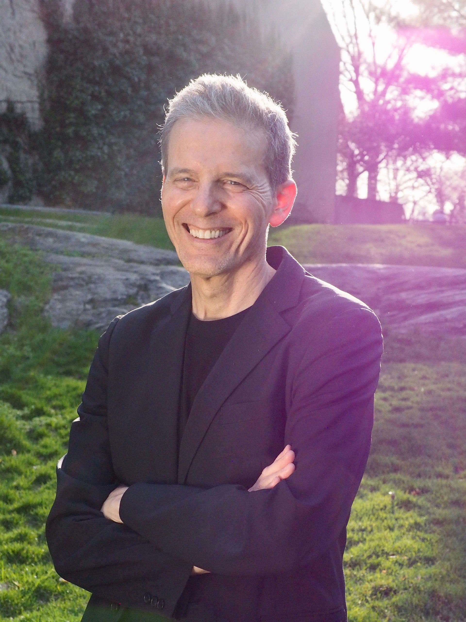 Nachum Kligman, a man in a suit and tie is smiling for the camera.
