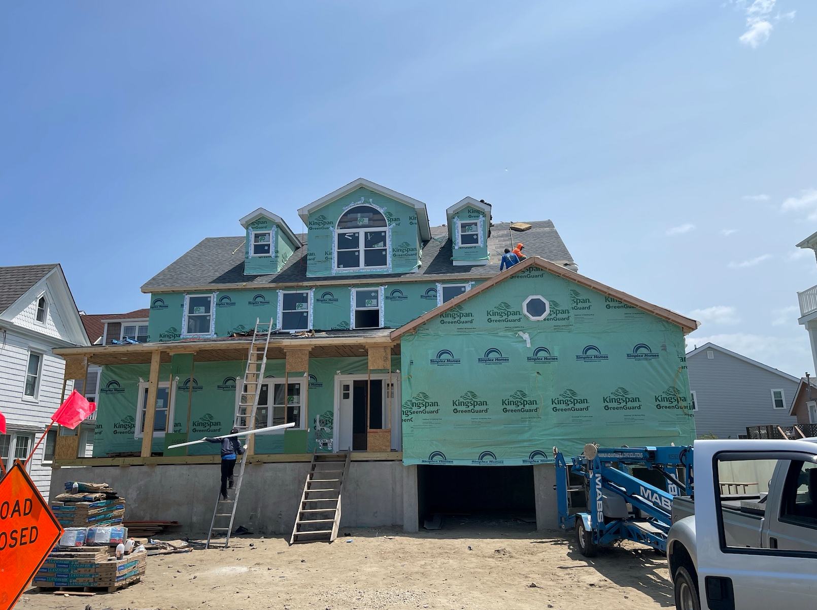 A large house is being built in a residential area.