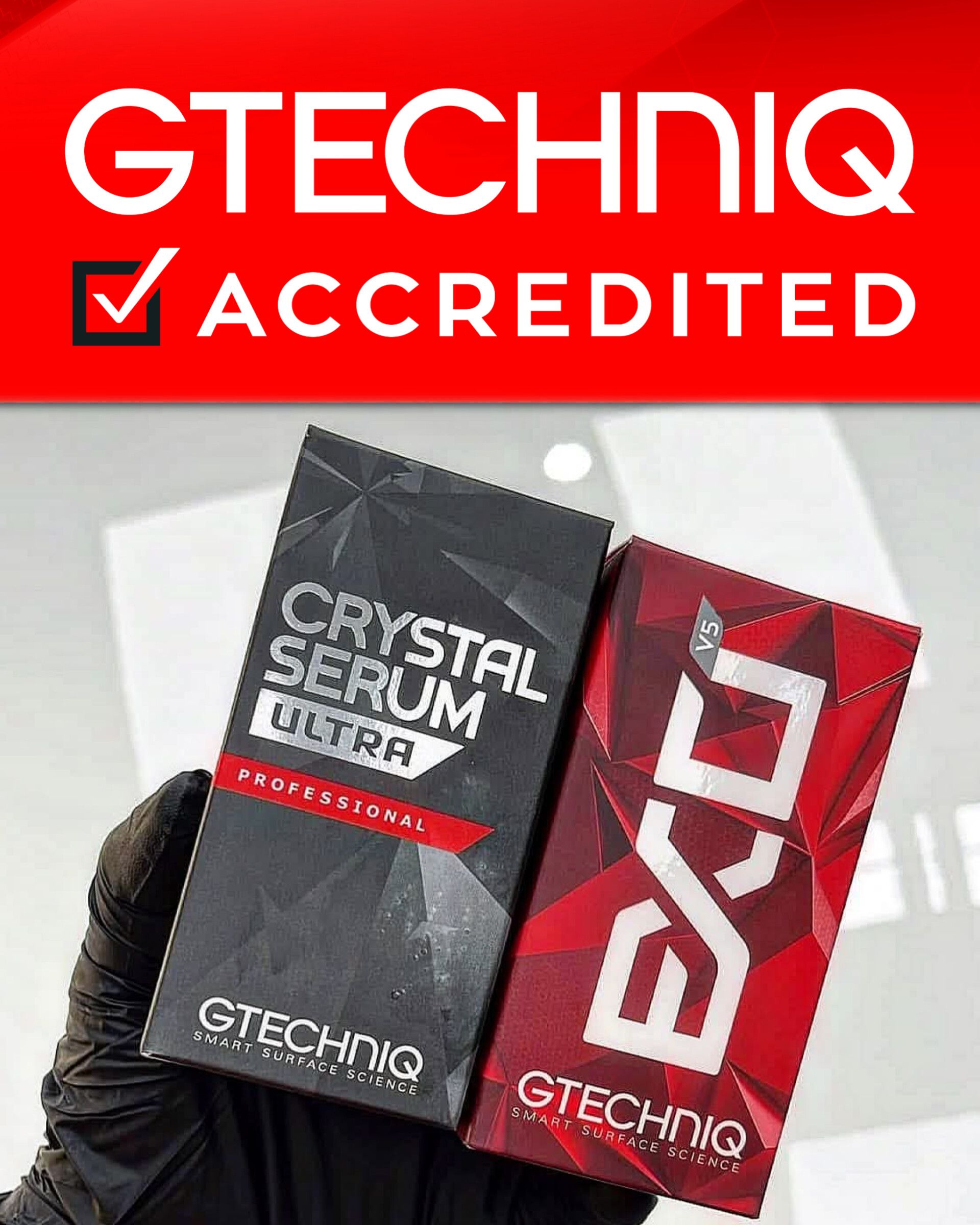 A person is holding two boxes of gtechniq products