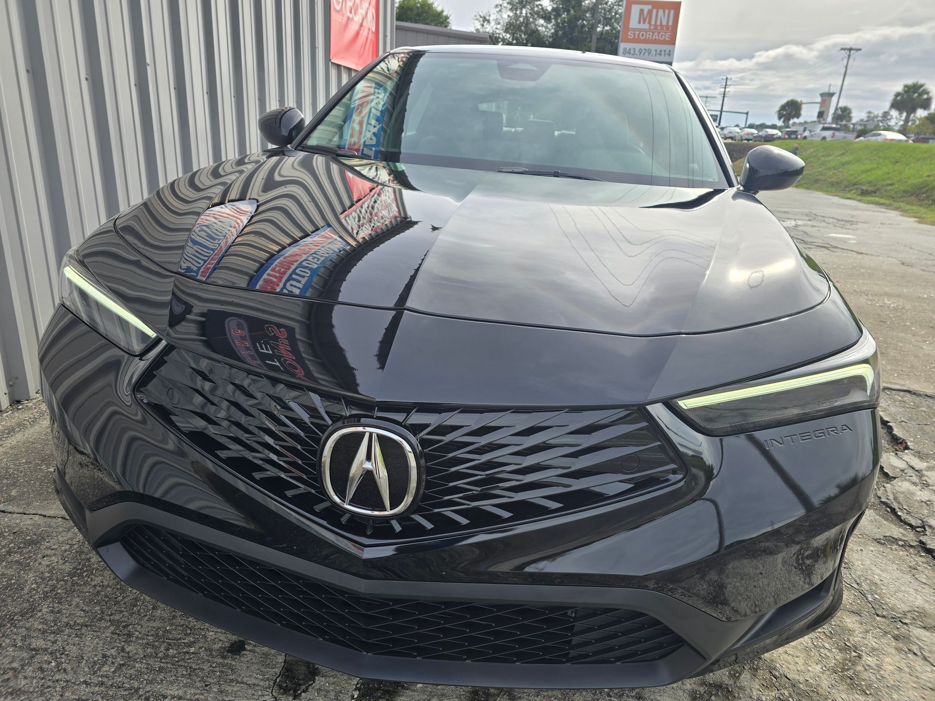 A black acura integra is parked in front of a building.