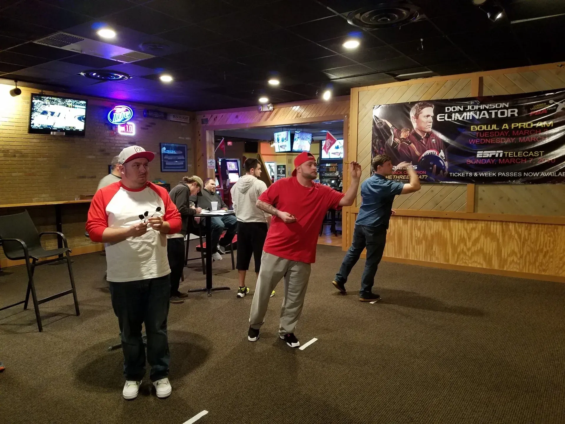playing darts in a league at a bar, tavern, or supper club