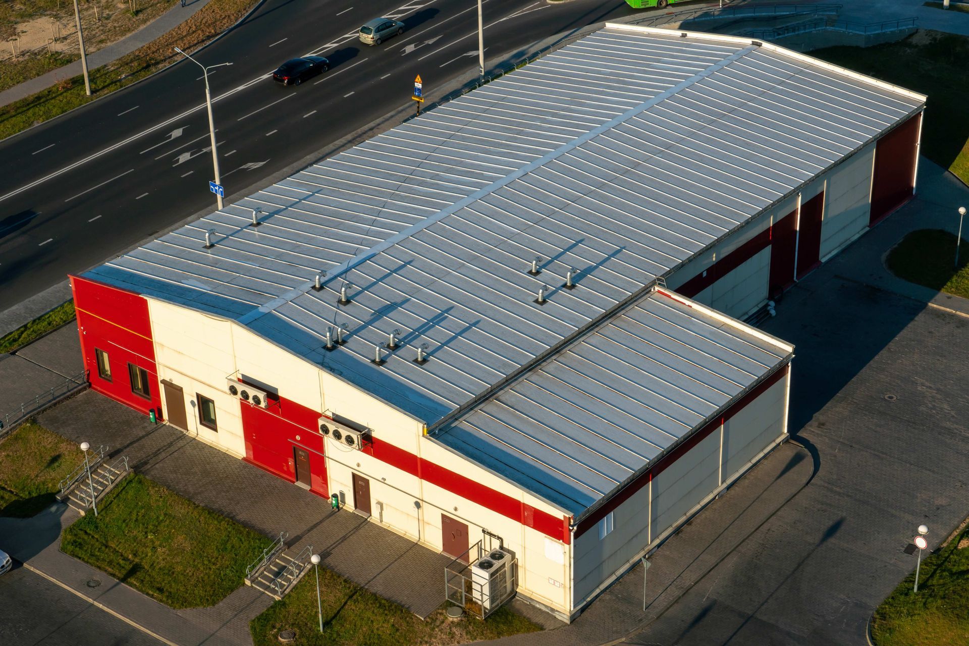 an aerial view of a large building with a blue roof