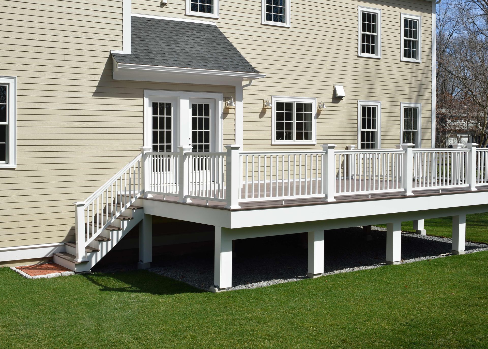 a large house with a large deck and stairs