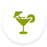 A green icon of a martini glass with an umbrella.