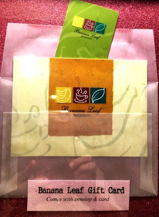 A banana leaf gift card in a plastic envelope
