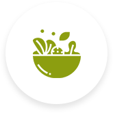 A green bowl filled with vegetables and leaves on a white background.