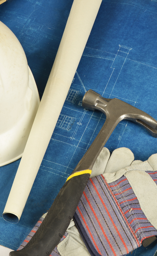 a hammer gloves and a hard hat are on a blueprint