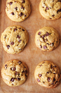 Chocolate chip cookies on parchment paper.