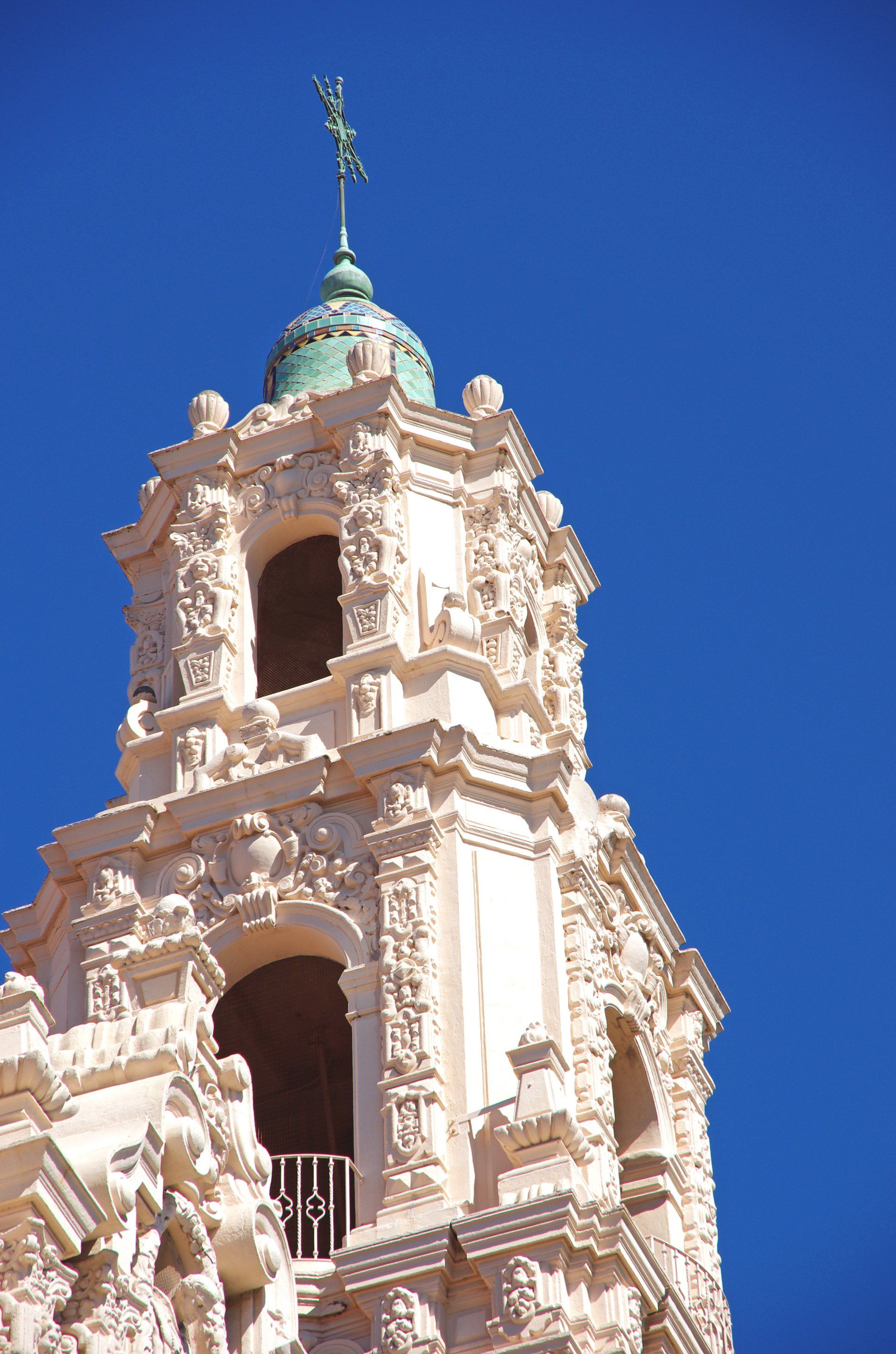 A very tall building with a green dome on top