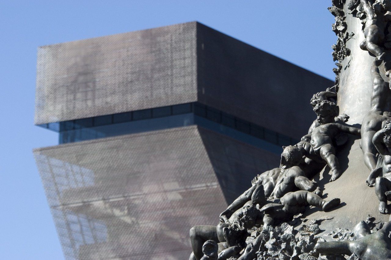 A large building with a statue in front of it