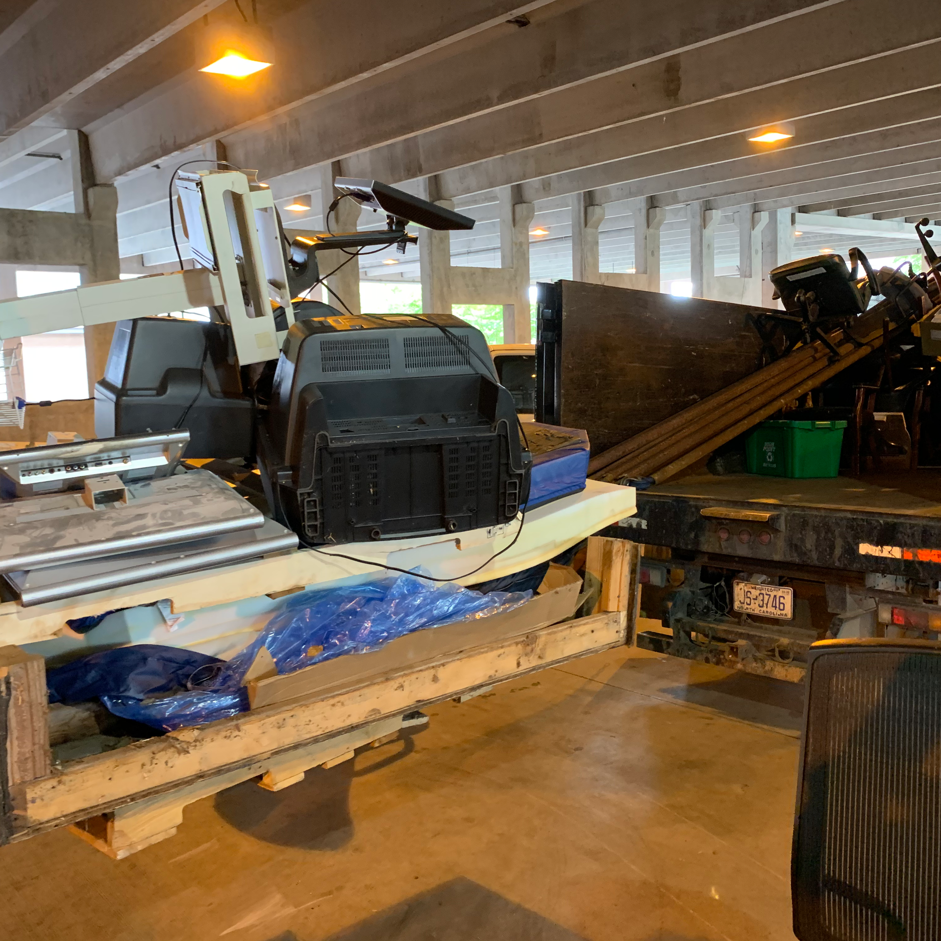 A boat is being towed by a tow truck in a garage.