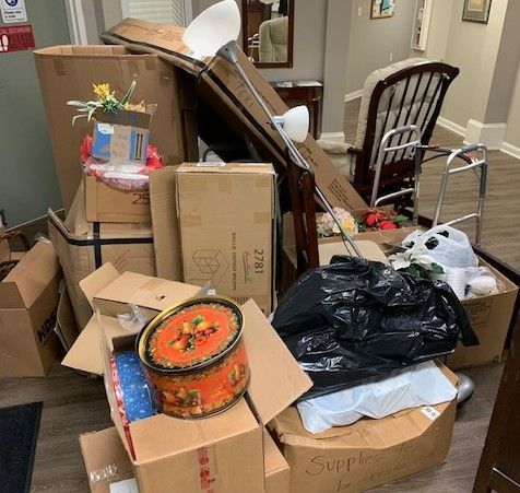 A room filled with lots of boxes and a walker.