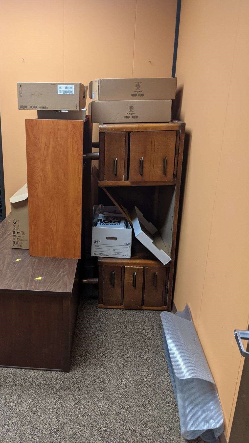 A room filled with lots of wooden furniture and boxes.