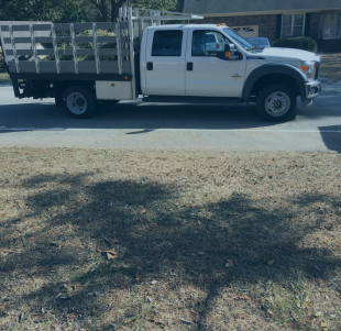 A white truck is parked on the side of the road