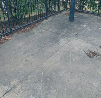 A pile of leaves on the ground in front of a house.